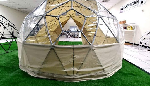 Testing the fit of a Sonstar mini glamping dome cover on a pentagonal window structure.